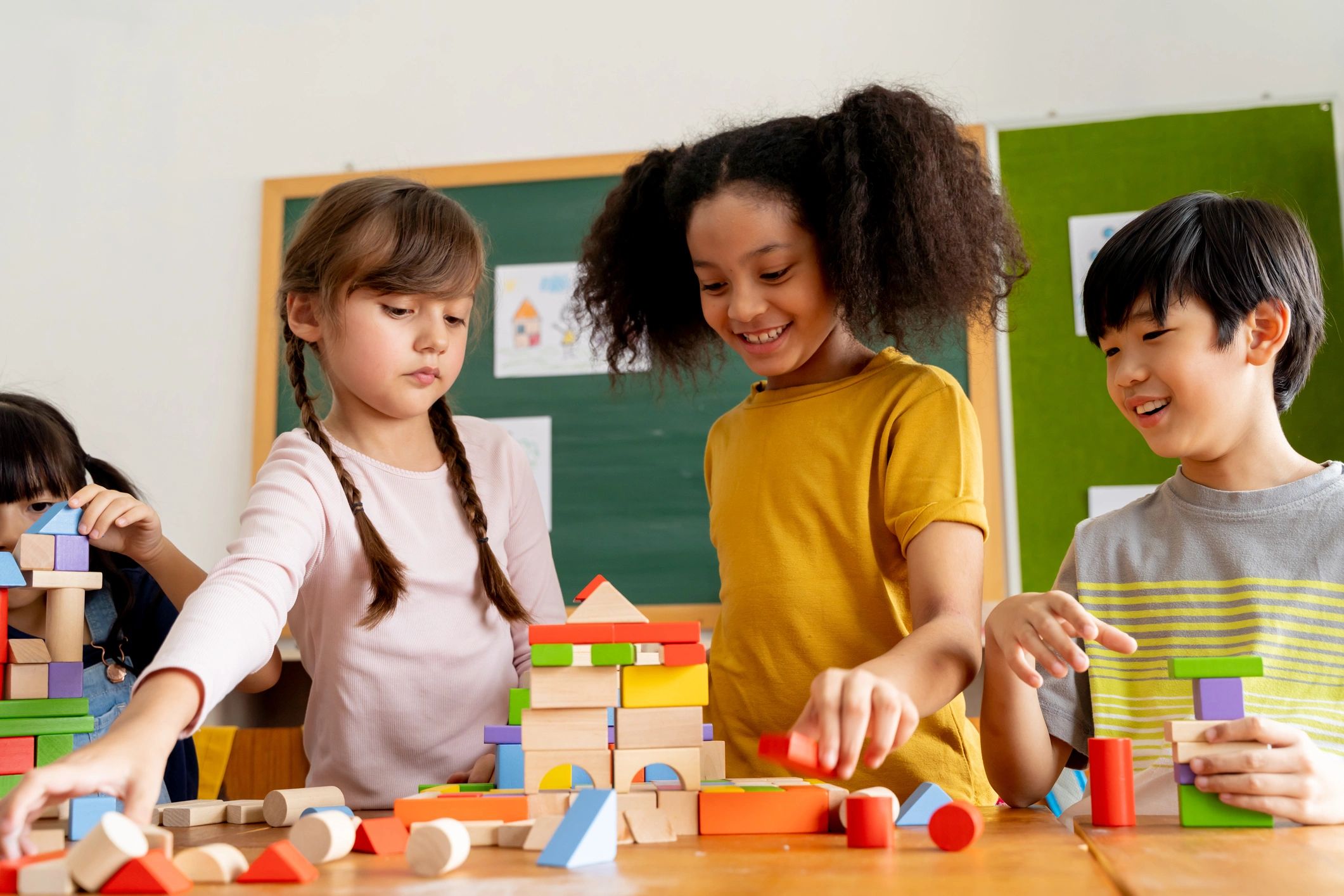 Children collaborating with wooden blocks in a classroom