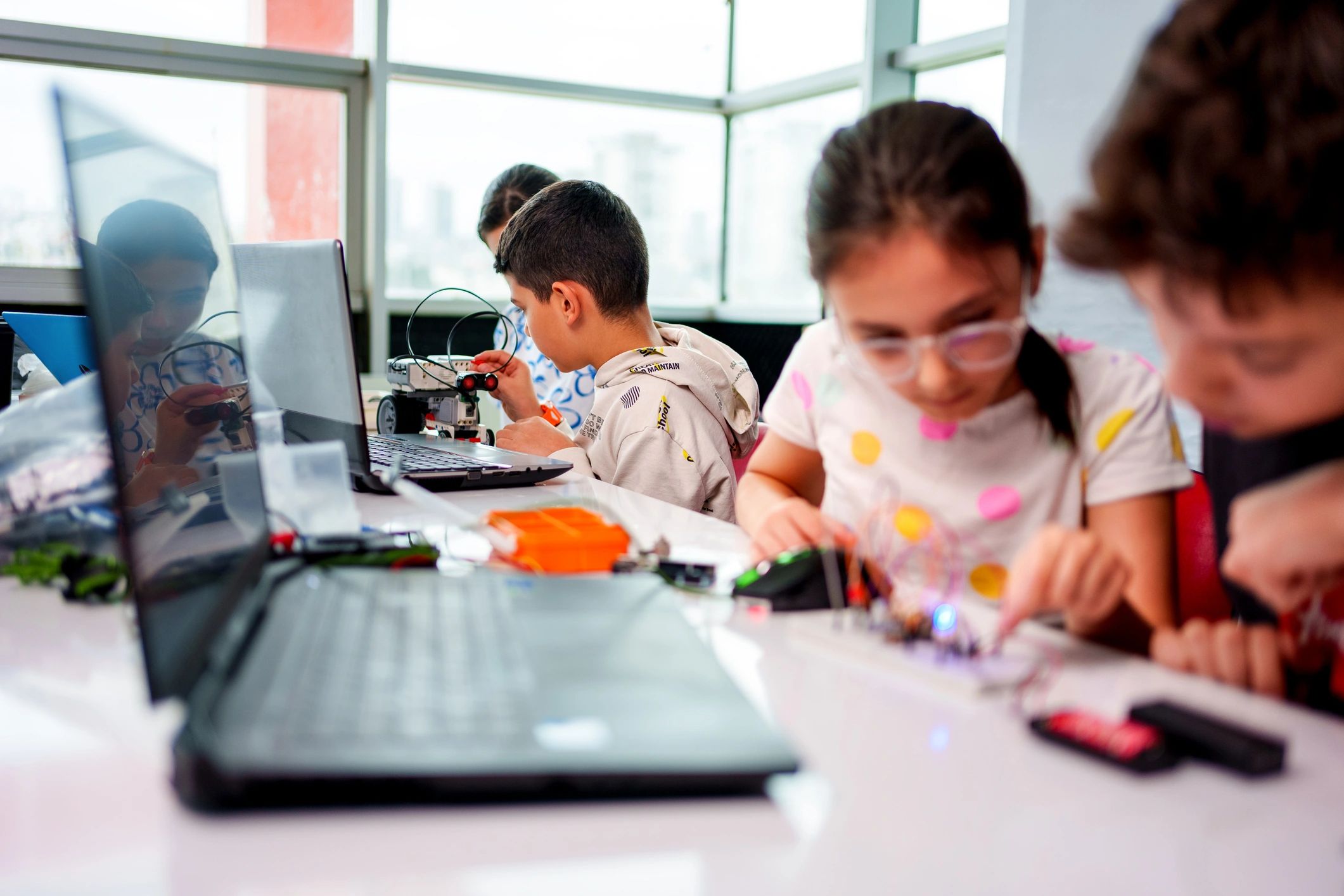 Children working together on a hands-on STEM robotics activity