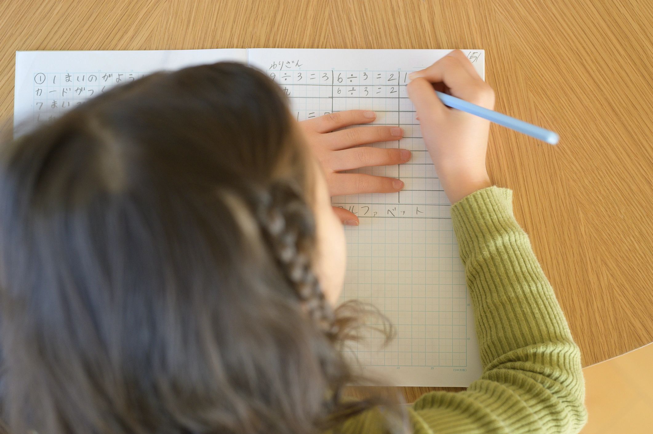 Student working through math problems in a notebook