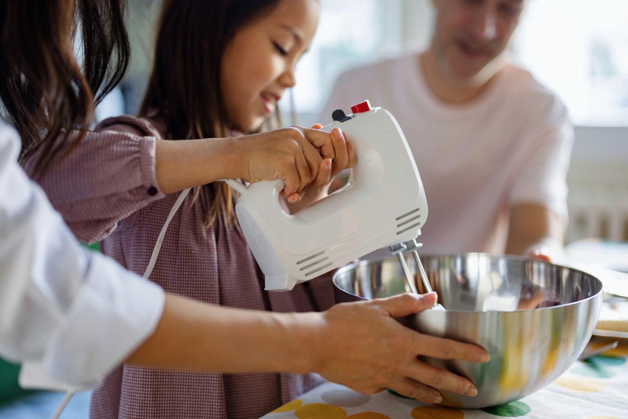 Hands mixing batter during a baking activity