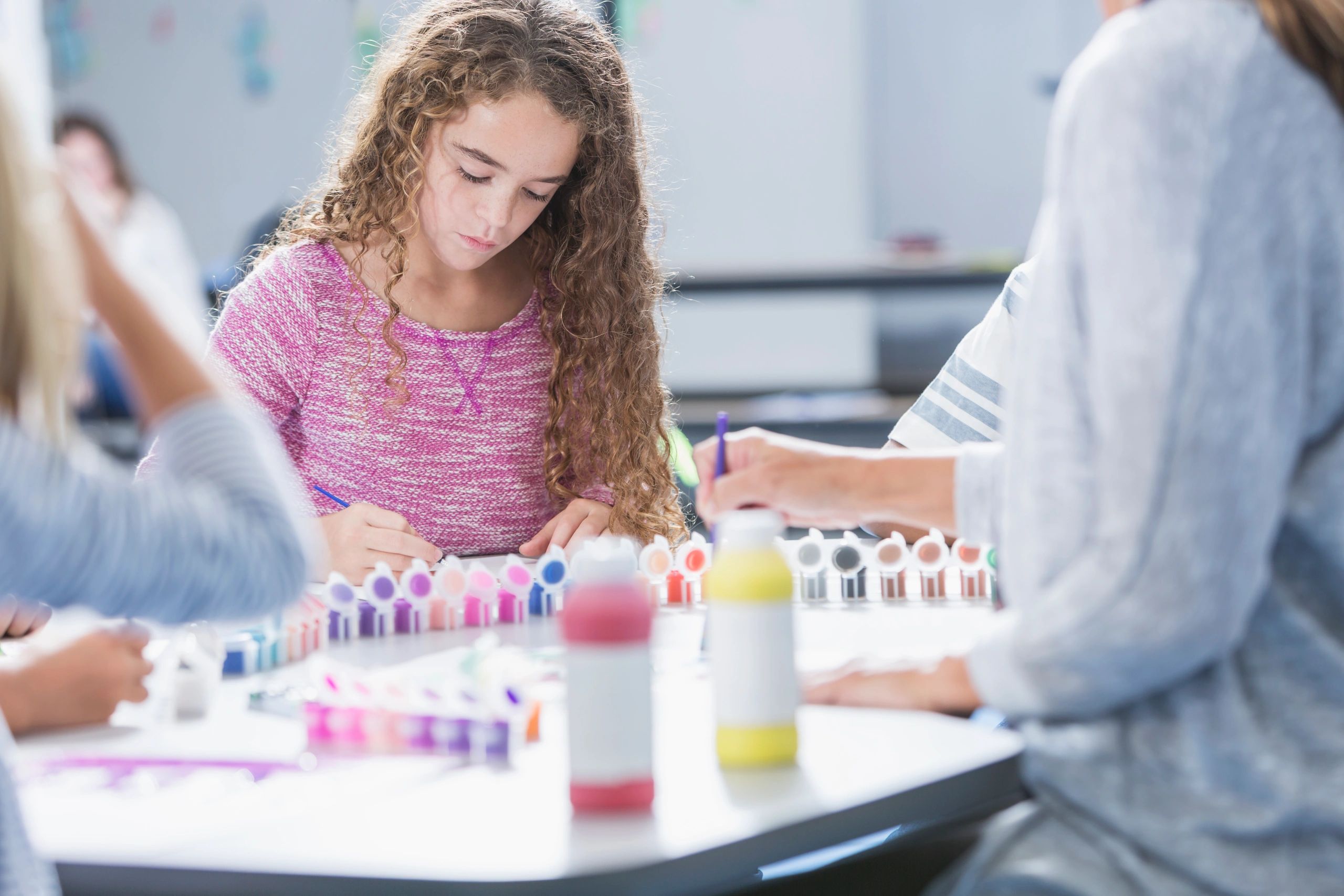 Student painting in an art class